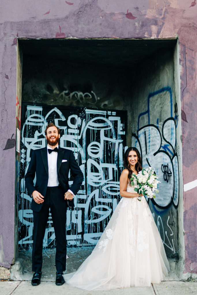 Wedding portrait in front of graffiti in Brooklyn